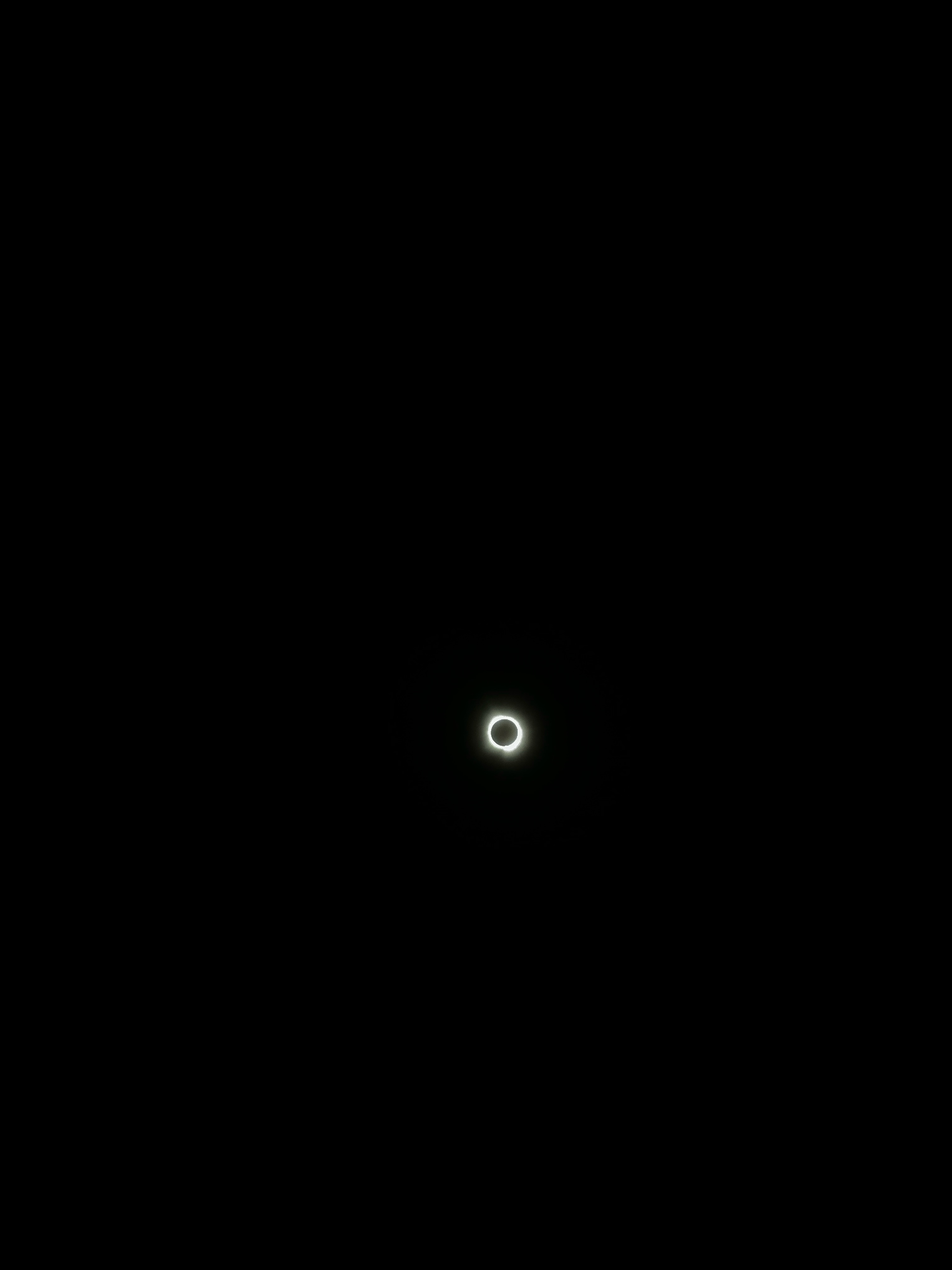 The solar eclipse seen as a distant ring against an all black background