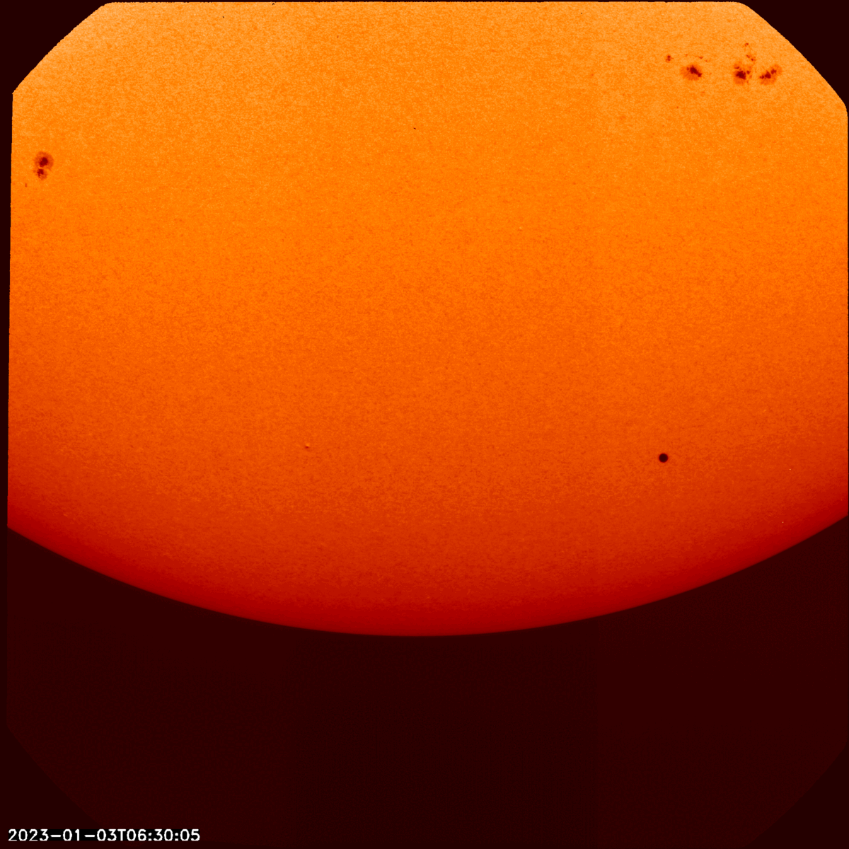Mercury, seen as a black dot, transiting across the sun