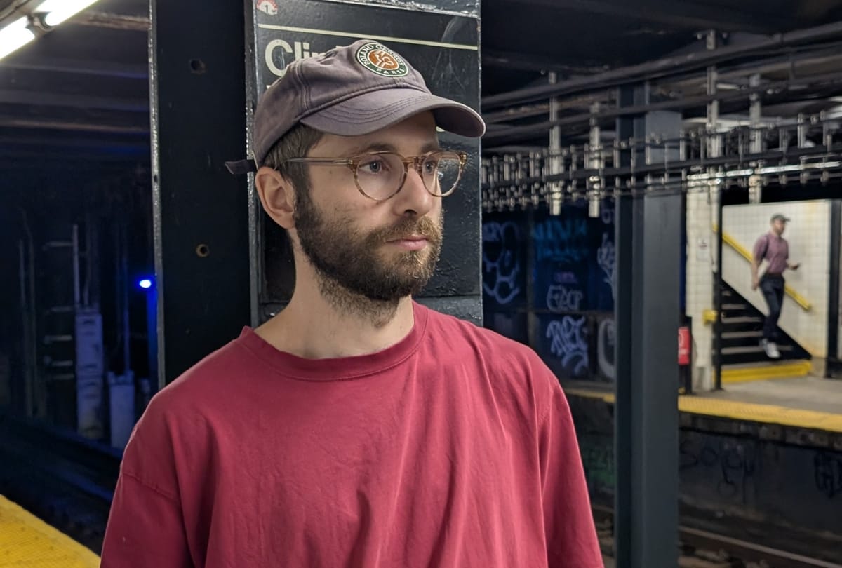 Photo of Jack Klein, founder of NewYorkLab standing on a subway platform in Brooklyn, NY.
