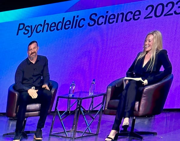 The neuroscientist Andrew Huberman sitting in a chair on a stage.